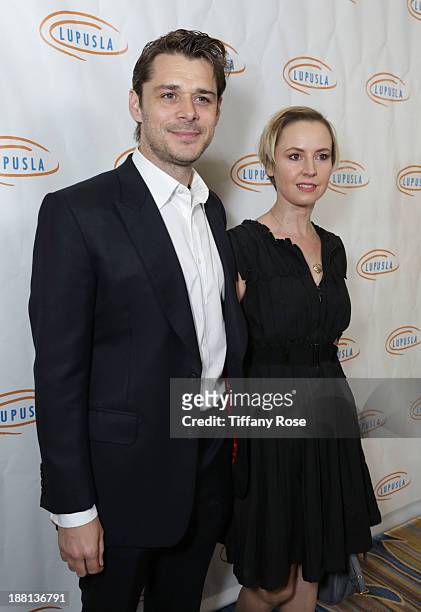 Actor Kenny Doughty and actress Caroline Carver attend the Hollywood Bag Ladies Luncheon on November 15, 2013 in Beverly Hills, California.