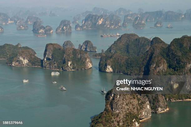 This aerial photo taken from a seaplane shows Ha Long Bay in Vietnam's northeastern province of Quang Ninh on December 28, 2023. Vietnam's Ha Long...