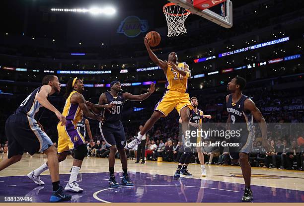 Jodie Meeks of the Los Angeles Lakers drives to the basket for a layup between Zach Randolph and Tony Allen of the Memphis Grizzlies in the first...