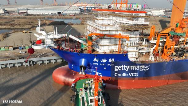 China's first dual-fuel powered trailing suction dredger, Xinhaixun, enters water on December 24, 2023 in Qidong, Nantong City, Jiangsu Province of...