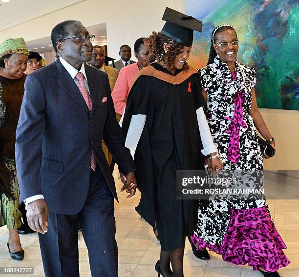 Zimbabwes President Robert Mugabe and his wife Grace with their 24-year-old first-born child and only daughter Bona Mugabe leave the convocation at...
