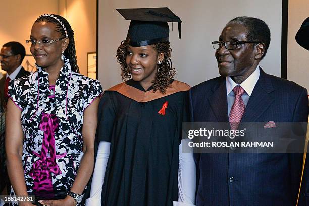 Zimbabwes President Robert Mugabe and his wife Grace with their 24-year-old first-born child and only daughter Bona Mugabe pose after the convocation...