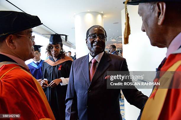 Zimbabwes President Robert Mugabe with his 24-year-old first-born child and only daughter Bona Mugabe attend the convocation at MDIS-University of...