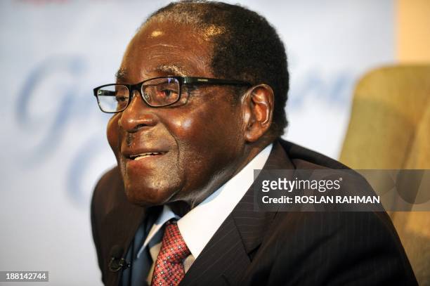 Zimbabwes President Robert Mugabe talks to the media after attending his 24-year-old first-born child and only daughter Bona Mugabe's convocation at...