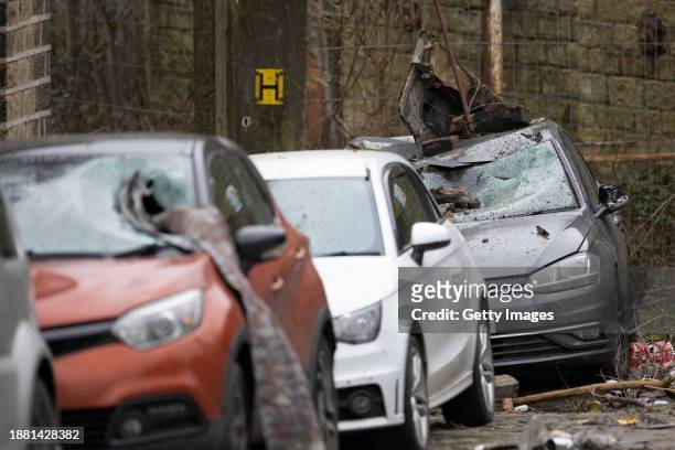 Damaged cars are seen outside a home following a tornado on December 28, 2023 in Stalybridge, England. Houses in the Tameside area of Greater...