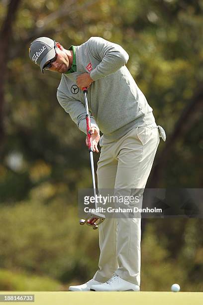 Adam Scott of Australia makes a putt during round three of the 2013 Australian Masters at Royal Melbourne Golf Course on November 16, 2013 in...