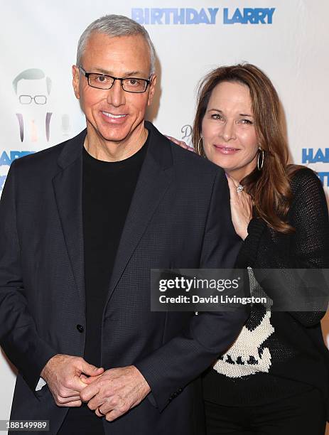 Personality Dr. Drew Pinsky and wife Susan Pinsky attend Larry King's 80th birthday surprise party at Dodger Stadium on November 15, 2013 in Los...