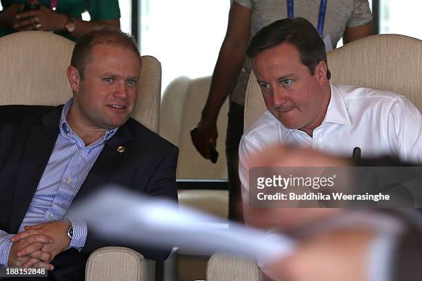 United Kingdom Prime Minister David Cameron talks with Malta Prime Minister Dr. Joseph Muscat during a working session of the Commonwealth Heads of...