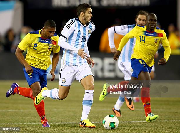 Ricardo Alvarez of Argentina takes the ball as Segundo Castillo of Ecuador defends during a friendly match at MetLife Stadium on November 15, 2013 in...