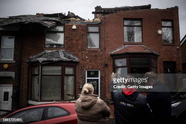 The residents of the house which had the roof ripped up assess the damage in the aftermath of a tornado on December 28, 2023 in Stalybridge, England....