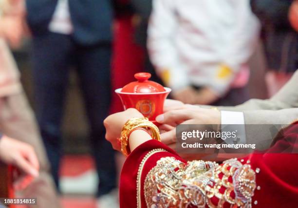 in a traditional chinese wedding, the bride and groom offer tea to their elders - tea ceremony stock pictures, royalty-free photos & images
