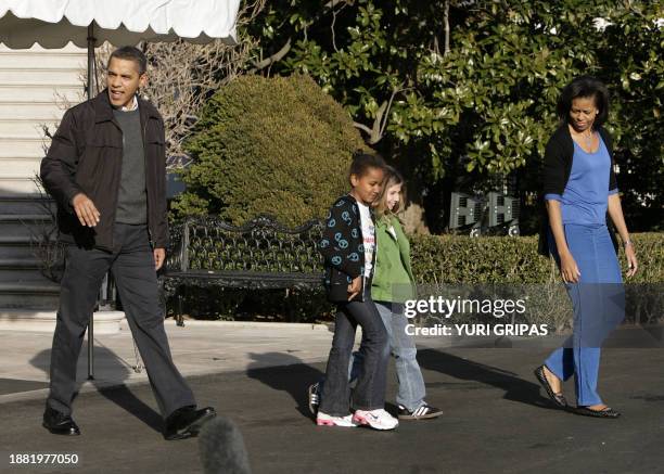 President Barack Obama walks with first lady Michelle , daughter Sasha and an unidentified friend walk on the South Lawn of the White House in...