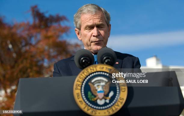 President George W. Bush pauses while speaking on the economy on the South Lawn of the White House in Washington, DC, on December 5, 2008. President...