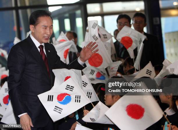 South Korean President Lee Myung Bak is welcomed by kindergartners as he arrives at the Kyushu National Museum for a meeting with Taro Prime...