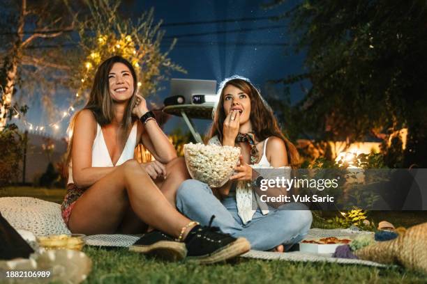 watching a movie and eating popcorn - white popcorn box stock pictures, royalty-free photos & images