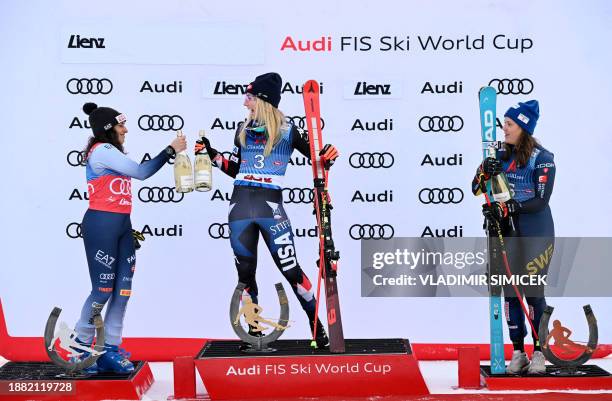 Second placed Italy's Federica Brignone, winner US' Mikaela Shiffrin and third placed Sweden's Sara Hector pose for a picture after the Women's Giant...