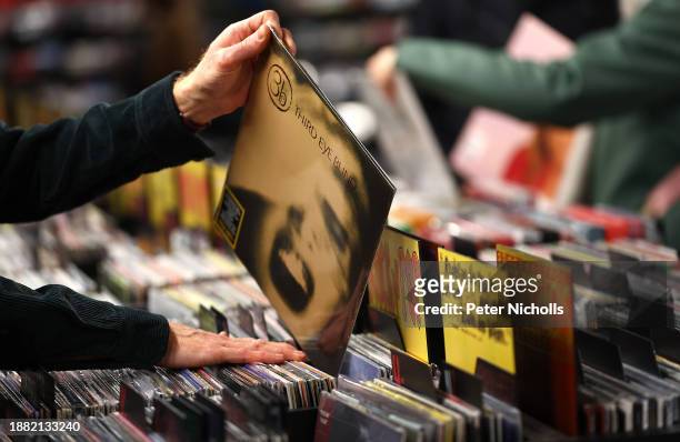 Customer looks through a rack of vinyl records at the HMV store on Oxford street on December 28, 2023 in London, England. The British Phonographic...