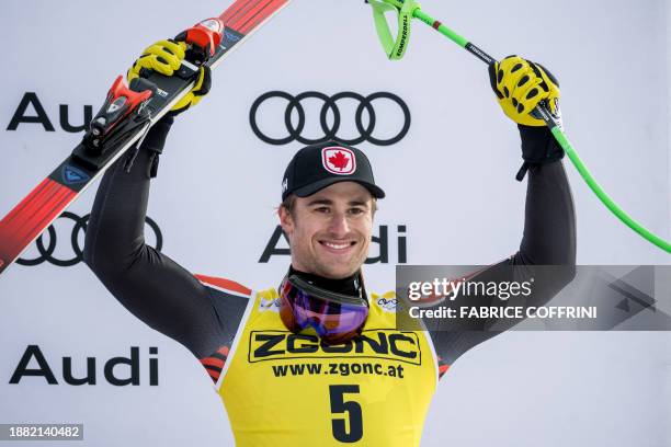 Third placed Canada's Cameron Alexander reacts during the podium ceremony after the Men's Downhill race at the FIS Alpine Skiing World Cup event in...