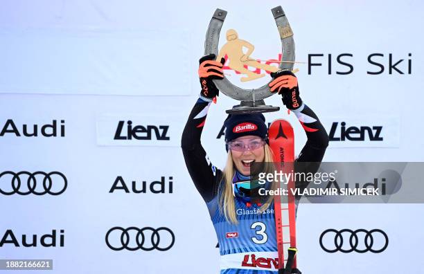 Winner US' Mikaela Shiffrin celebrates on the podium after the Women's Giant Slalom race at the FIS Alpine Skiing World Cup event on December 28,...