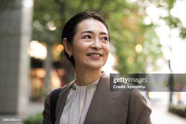 portrait of mid-age business woman - candid asian woman stock pictures, royalty-free photos & images