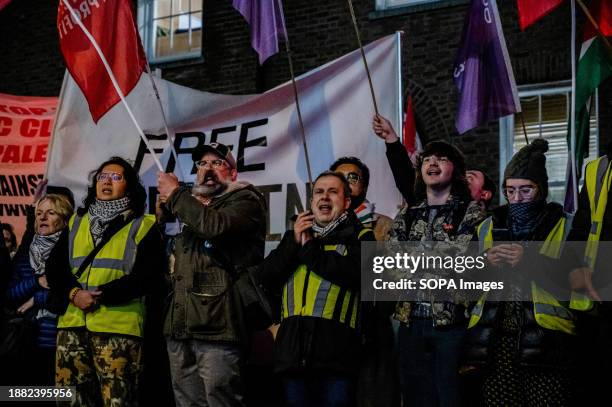 Protesters wearing yellow vests chant slogans and holds flags in solidarity with Palestine during the demosntration. Protesters rally in front of the...