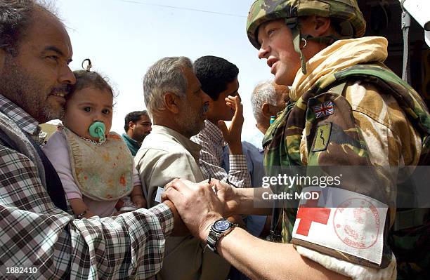 In this handout photo from the British Ministry of Defence, UK Colonel Dunken Robertson of 4 General Support Regiment Medics provides medical...