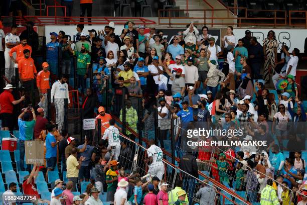 Supporters cheer as South Africa's Dean Elgar and South Africa's Kagiso Rabada walks back to the pavilion after South Africa won the first cricket...