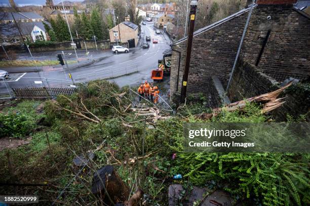 Electricity workers secure power lines after a tree fell onto the Royal Oak Pub in the aftermath of a tornado on December 28, 2023 in Stalybridge,...