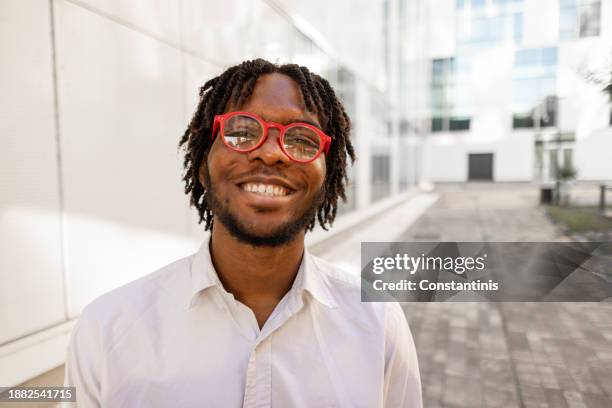 young male student black ethnicity in front of the modern university - person of colour stock pictures, royalty-free photos & images
