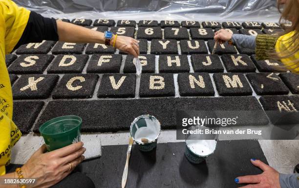 Irwindale, CA Volunteers decorate Coding for Veterans Rose Parade float titled "Sounds of Success" at Phoenix Decorating Company on Wednesday, Dec....