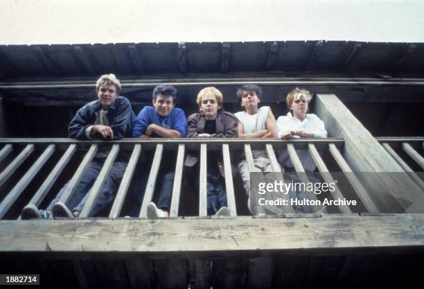 British pop group Duran Duran looking down from a balcony, c. 1983. L-R: Singer Simon Le Bon, bassist Andy Taylor, keyboardist Nick Rhodes, drummer...