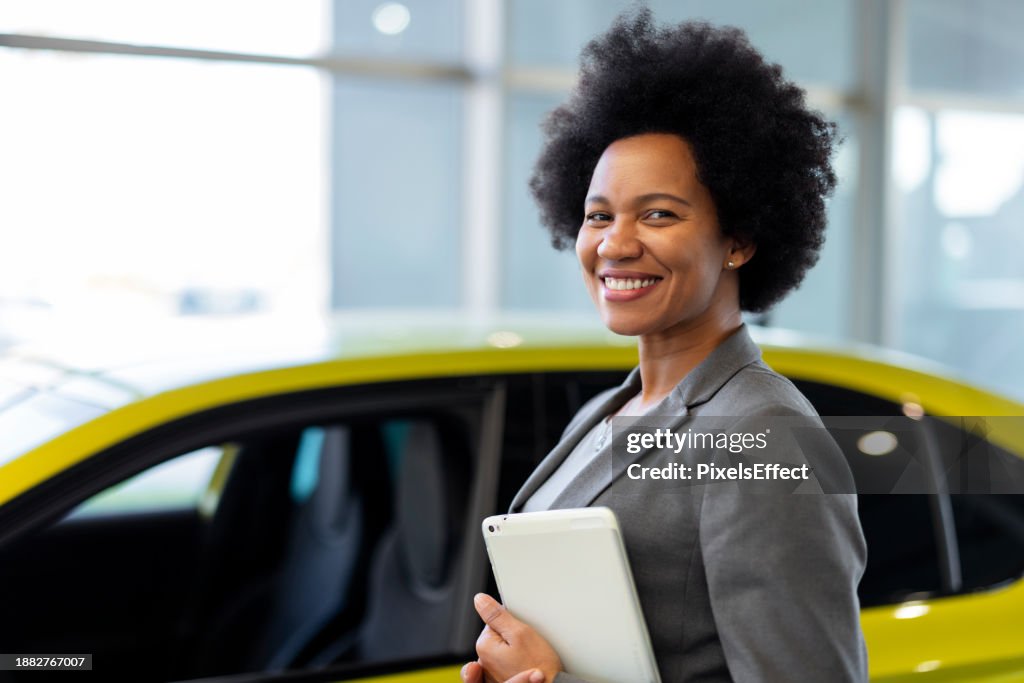 Black Saleswoman Posing at Auto Showroom