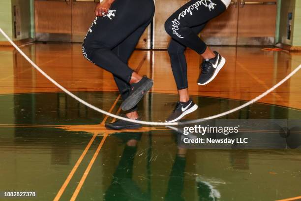 Closeup of the legs and feet of two women performing Double Dutch jump rope at The Dutchess of Ropes meetup in Farmingdale, New York on December 19,...