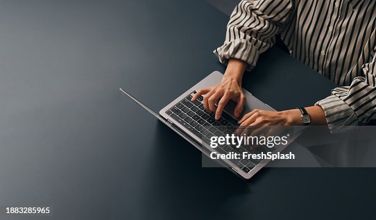An Unrecognizable Businesswoman Working In Her Office On Her Computer An Unrecognizable Businesswoman Working In Her Office On Her Computer