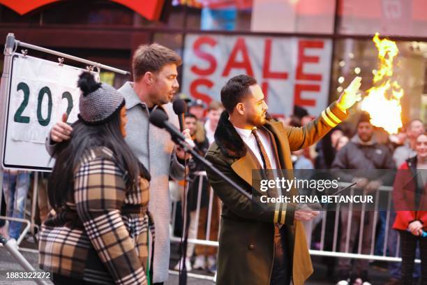 Magician burns a note written by a woman as people gather to rip up bad memories during the annual Times Square Good Riddance Day in New York on...