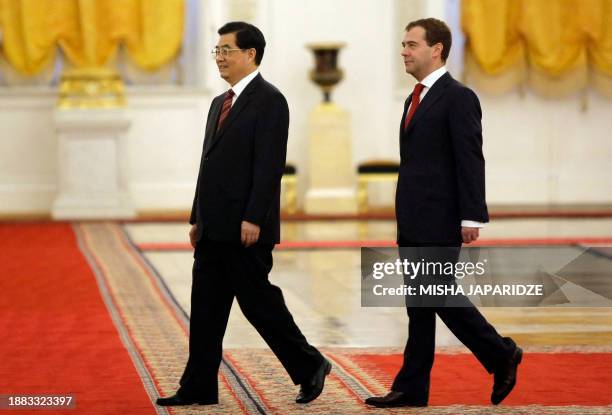 Russian President Dmitry Medvedev and Chinese President Hu Jintao walk during an official welcoming ceremony in Moscow's Kremlin on June 17, 2009. Hu...