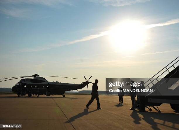 President Barack Obama makes his way to board Air Force One 02 June 2009 at Dulles International Airport in Chantilly, Virginia. Obama is starting a...