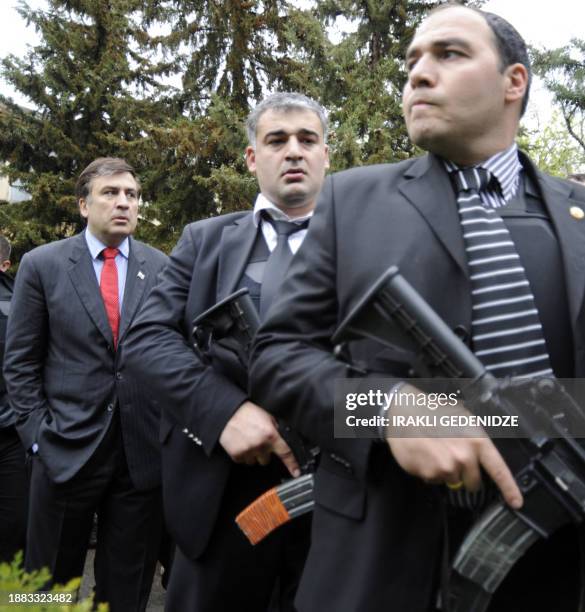 Georgian President Mikheil Saakashvili is guarded by bodyguards at the Mukhrovani military base some 10 km outside of Tbilisi May 5, 2009. A military...