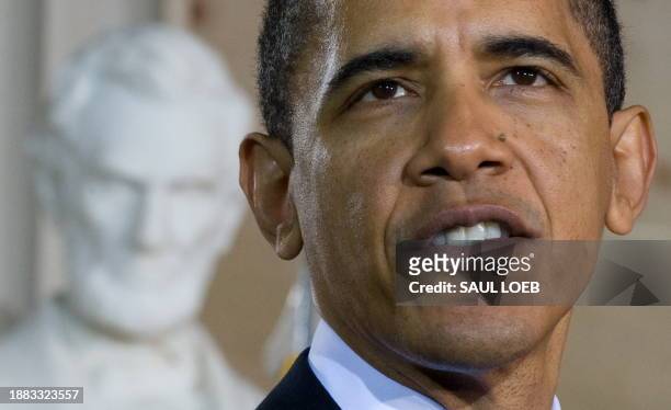 President Barack Obama speaks alongside a statue of former US President Abraham Lincoln during the National Holocaust Museum Days of Remembrance...