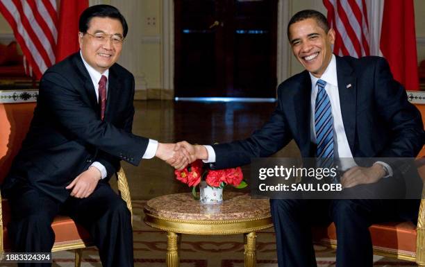 President Barack Obama meets with Chinese President Hu Jintao during meetings at the Winfield House, the US Ambassador's residence in London,...