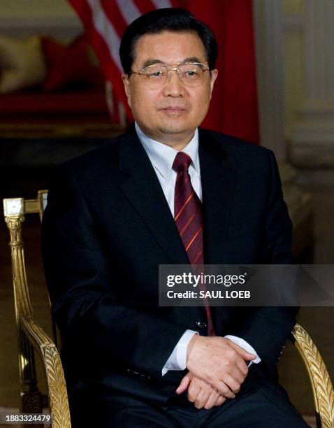 China's President Hu Jintao listens during a meeting with US President Barack Obama at the Winfield House, the US Ambassador's residence in London,...