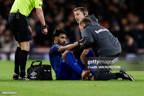 West Ham United's Brazilian midfielder Lucas Paqueta receives medical attention during the English Premier League football match between Arsenal and...