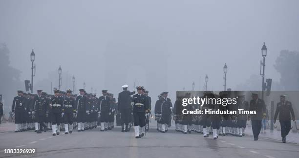 Indian coast guard personnel during rehearsals for the upcoming Republic Day parade amid fog on a cold winter morning on December 28, 2023 in New...