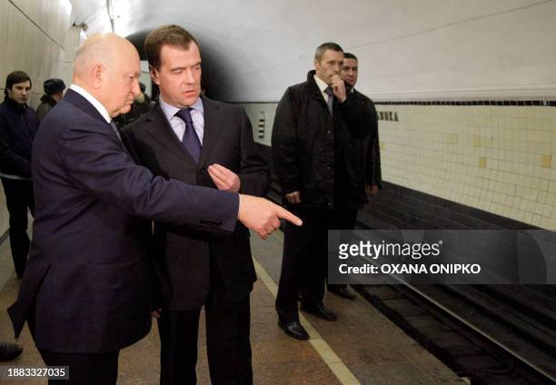 Russian President Dmitry Medvedev and the Mayor of Moscow Yuri Luzhkov inspect the site of the blast at the Lubyanka metro station in Moscow on March...