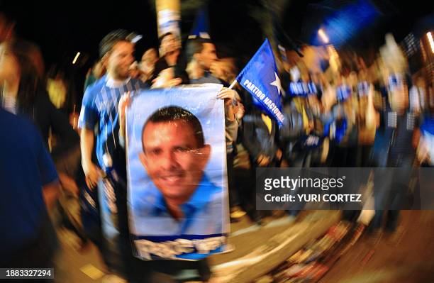 Supporters of Honduran presidential candidate for the National Party, Porfirio Lobo, celebrate in the streets the preliminary and non official...