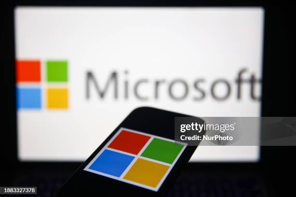 Microsoft logo displayed on a laptop screen and Microsoft logo displayed on a phone screen are seen in this illustration photo taken in Krakow,...