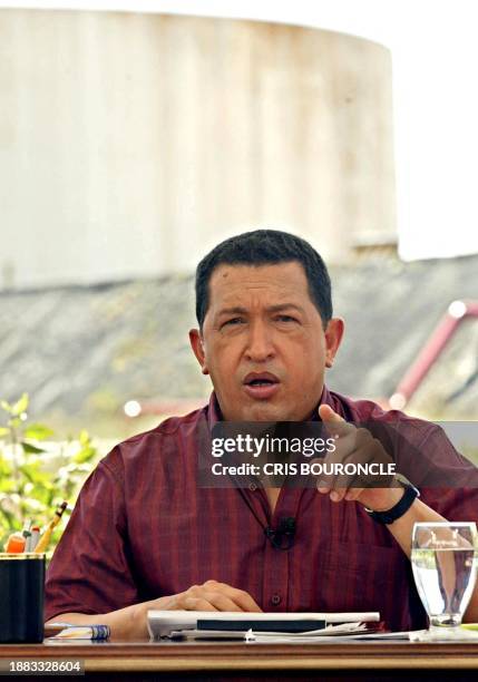 Venezuelan President Hugo Chavez points as he speaks during the weekly radio show "Hello President" at the Carenero gasoline distribution plant some...