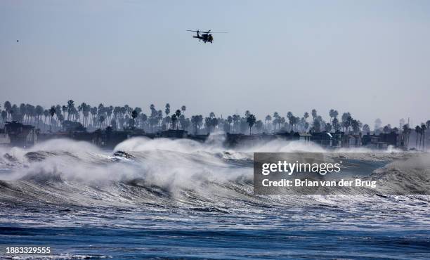 Ventura, CA Ventura County fire helicopter patrols the coastline over heavy surf south of Ventura Pier on Thursday, Dec. 28, 2023 in Ventura, CA....