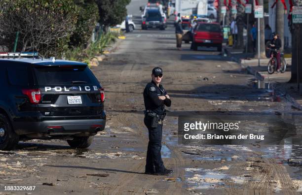 Ventura, CA A Ventura police officer keeps watch as authorities closed the beaches around the Pierpont neighborhood due to dangerous conditions on...