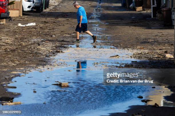 Ventura, CA A man crosses a flooded Montauk Lane in Pierpont after seawater inundated the area during heavy surf at high tide on Thursday, Dec. 28,...